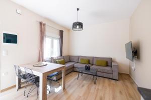 a living room with a couch and a table at Christiana's Cottage in Sidari