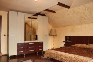 a bedroom with a bed and a large mirror at Amelia House in Făgăraş