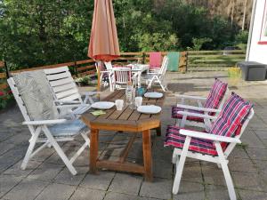 a group of chairs and a table and an umbrella at Villa Viriditas in Elbingerode