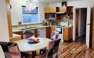 a kitchen with a table with a bowl of food on it at Ahuriri Escape - Home Away Home, Entire Bungalow in Napier