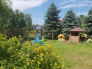 a garden with a playground and a gazebo at Pokoje Irys in Kazimierz Dolny +17 photos