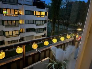a balcony with lights in front of a building at Cozy Modern Apartment with Small Balcony in the Heart of Berlin in Berlin