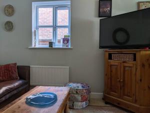 a living room with a couch and a table at Appletree House 