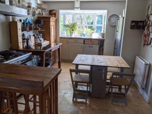 a kitchen with a table and chairs and a stove at Appletree House 