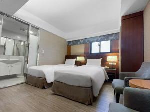 Postel nebo postele na pokoji v ubytování Guide Hotel Taipei NTU