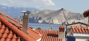 a view of the mountains from the roofs of buildings at Old Town Baska in Baška