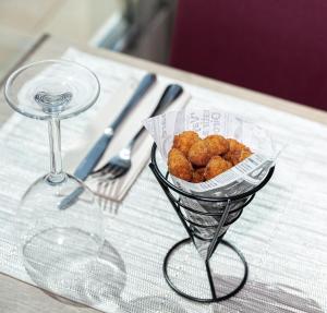 a basket of food on a table with a wine glass at Hotel Ankaa - Adults Only in Porto Cristo