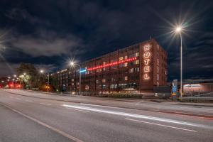 a building on a street at night with street lights at Mornington Hotel Bromma in Stockholm