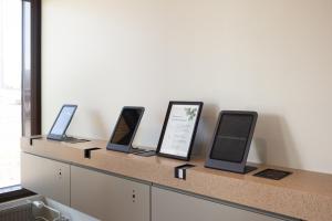 a row of tablet computers sitting on a counter at Noli Herttoniemi in Helsinki