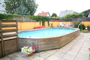 a large swimming pool in a backyard with a fence at Hotel Reinisch in Köflach