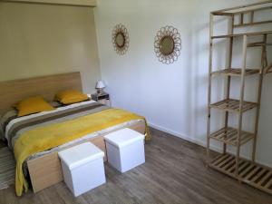 a bedroom with a bed and two white shelves at Au Grand Chêne Jolie T3 à 5 min d'Albi in Puygouzon-et-Montsalvy