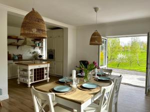 a kitchen and dining room with a table and chairs at Lake House Family in Wiewiecko