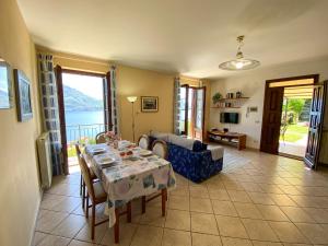 a living room with a table and a couch at Torre Ferienwohnung mit Garten in San Siro +24 photos