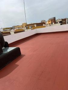 a black couch sitting on top of a roof at bajo en casa unifamiliar terraza in Seville