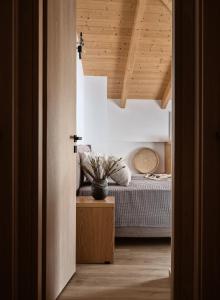 a bedroom with a bed and a wooden ceiling at Giannoulis City Apartments in Zakynthos
