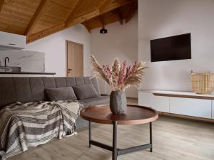 a living room with a couch and a table at Giannoulis City Apartments in Zakynthos