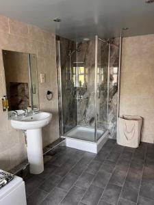 a bathroom with a sink and a shower at The Ring O'Bells in Halifax