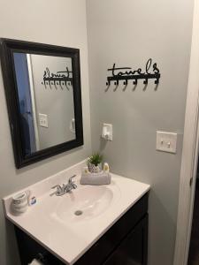 a bathroom with a sink and a mirror at 2Bdrm Comfortable Townhome 5 Mins from Airport in Atlanta