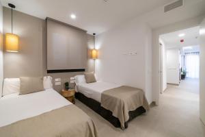 Alidreams Lola Center Apartamentos客房内的一张或多张床位