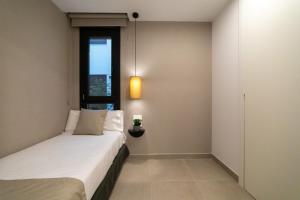 Alidreams Lola Center Apartamentos客房内的一张或多张床位
