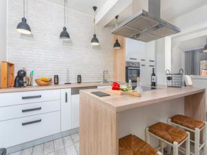 a kitchen with white cabinets and a large island at Apartment Brletic in Kastav +21 photos