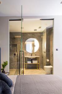 a bedroom with a large glass shower and a toilet at Hotel Atrium in Kraków