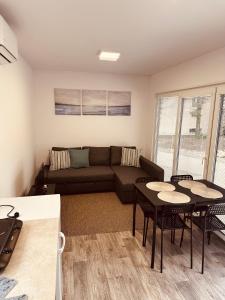 a living room with a couch and tables and chairs at Residence 7 in Štúrovo