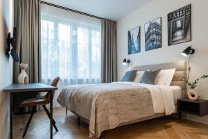 a bedroom with a bed and a desk and a window at N48 Boutique Hotel in Tallinn
