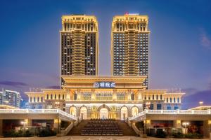 a building with two tall buildings in the background at Courtyard by Marriott Foshan in Foshan