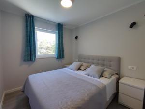 Postel nebo postele na pokoji v ubytování Apartments Ivančić