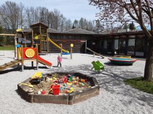 a child playing in a sandbox in a playground at Campingfass Almtal in Scharnstein