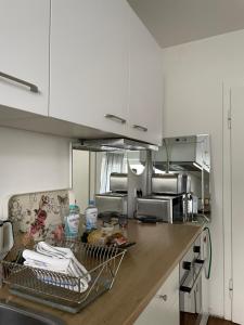 a kitchen with white cabinets and a counter top at Private room in Misburg, Hanover in Hannover