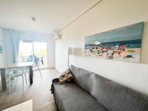 a living room with a couch and a table at Dorado Amanecer frente al Mar in Oropesa del Mar