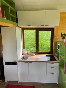 a kitchen with a white refrigerator and a window at Tiny Heaven Chidea 