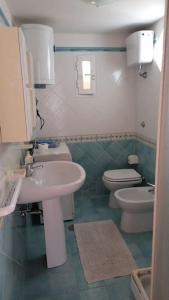 a bathroom with a sink and a toilet at A casa di nonna Elvira in Vietri sul Mare