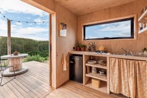 a kitchen with a deck with a sink and a window at Luxury yurt glamping at Littlegrove in Adventure Bay