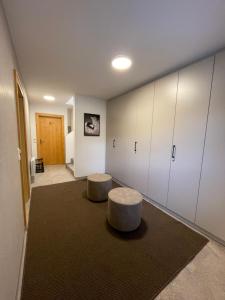 a room with two stools in a room with white cabinets at Ferienwohnung Königsleiten 121a - Top 1 in Königsleiten