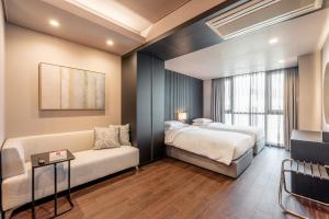 Postel nebo postele na pokoji v ubytování Haeundae Centum Hotel