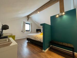 a bedroom with a bed and a green cabinet at De Horizon in Bullange