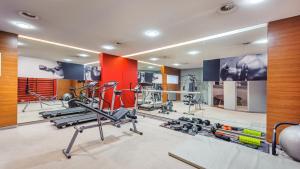 a gym with several exercise equipment in a room at Apartamenty Sun & Snow Parkur in Sopot