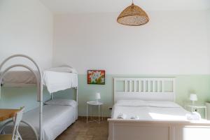 a bedroom with a bunk bed and a desk at Agriturismo Il Sorriso Degli Ulivi - Dimora di Charme in Gallipoli