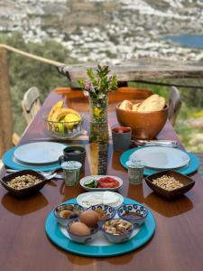 a table with plates and bowls of food on it at Mandra - Nature Living in Bodrum City