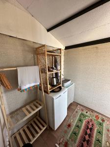 a small kitchen with a refrigerator and a stove at Mandra - Nature Living in Bodrum City