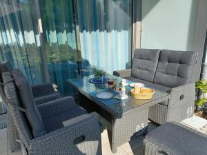 a patio table with two chairs and a tableasteryasteryasteryasteryasteryasteryastery at FeWo Am Meer Prora in Binz