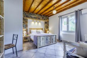 a bedroom with a bed and a window at Villa Maja in Skopelos Town