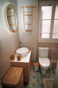 a bathroom with a toilet and a sink and a mirror at Casa nella Fortezza in Corfu