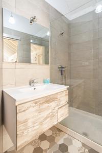 a bathroom with a white sink and a shower at Urbe10 Terrace Constitucion 1 Bedroom Apartment in Málaga