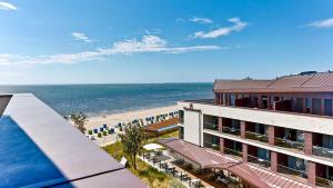 a view of the beach from a hotel at Upstalsboom Wyk auf Föhr in Wyk auf Föhr