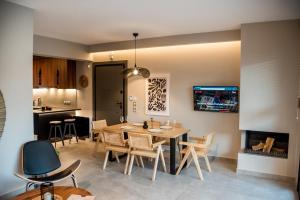 a dining room and kitchen with a table and chairs at Ambient Living in Preveza