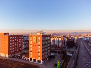 an overhead view of a city with buildings and a highway at Star Hill Hotel in Pristina